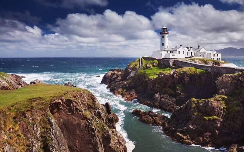 Lighthouse on Rocky Coast — Blue, Dramatic, Afternoon, Photograph, Ocean, Cliffs, Clouds