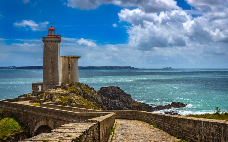 Lighthouse on Rocky Coast — Blue, Dramatic, Afternoon, Photograph, Ocean, Sky