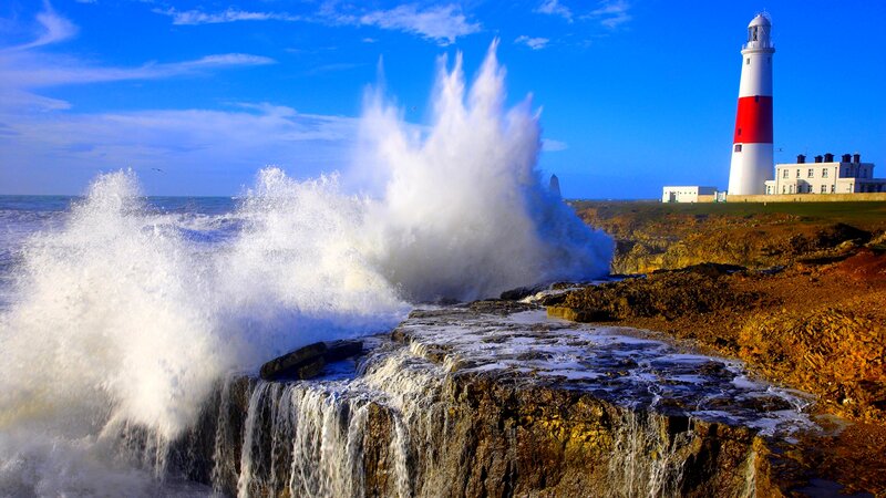 Lighthouse on Rocky Coast — Blue, Dramatic, Afternoon, Photograph, Waves