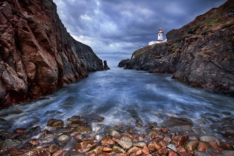 Lighthouse on Rocky Coast — Blue, Dramatic, Night, Photograph, Cliffs