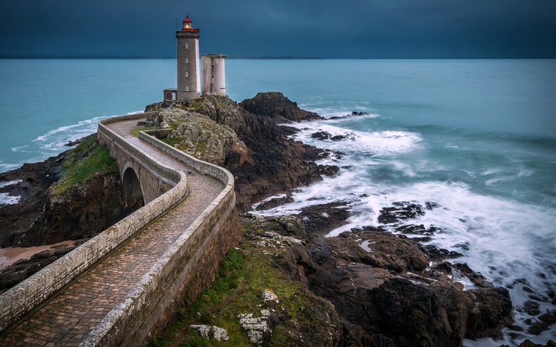Lighthouse on Rocky Coast — Blue, Dramatic, Night, Photograph, Ocean, Bridge