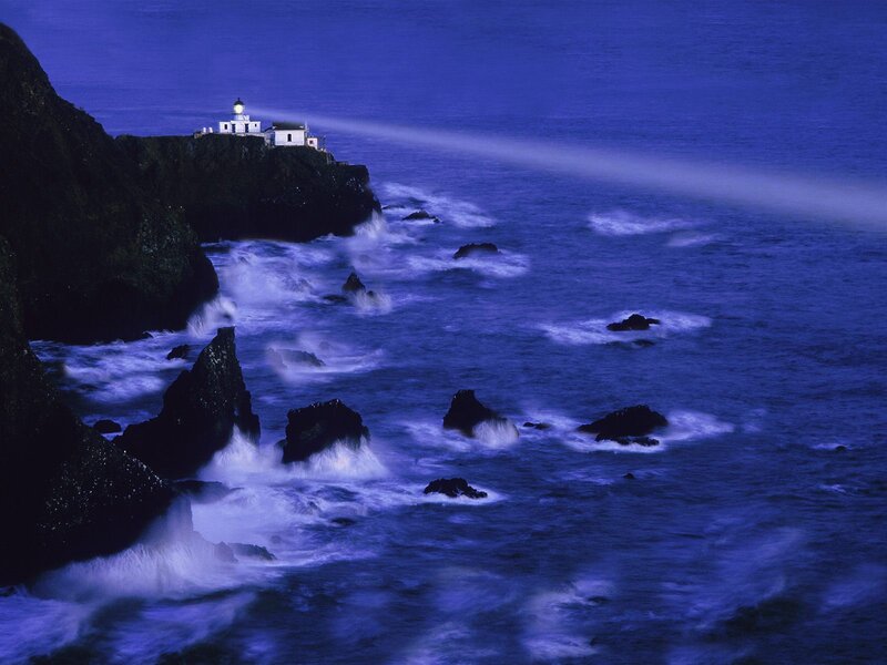Lighthouse on Rocky Coast — Blue, Dramatic, Night, Photograph, Ocean, Rocks