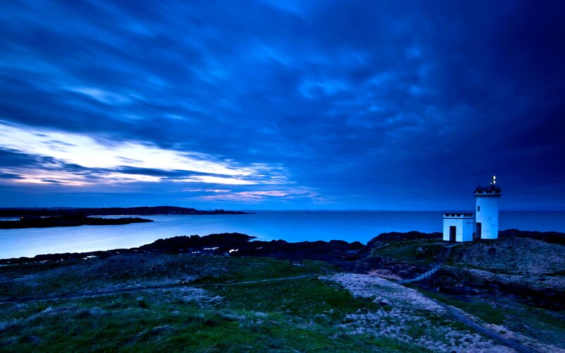 Lighthouse on Rocky Coast — Blue, Dramatic, Night, Photograph, Ocean, Sky