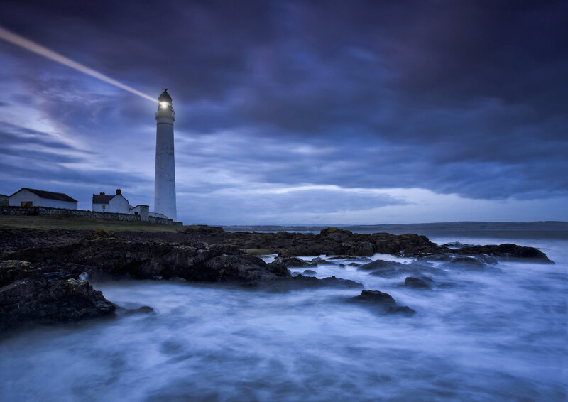 Lighthouse on Rocky Coast — Blue, Dramatic, Night, Photograph, Sea, Rocks