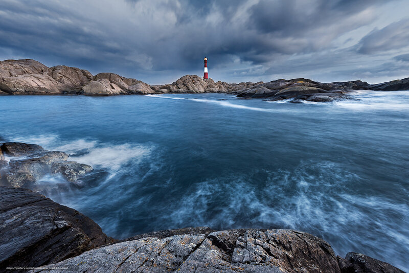 Lighthouse on Rocky Coast — Blue, Dramatic, Photograph, Rocks