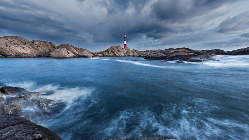 Lighthouse on Rocky Coast — Blue, Dramatic, Photograph