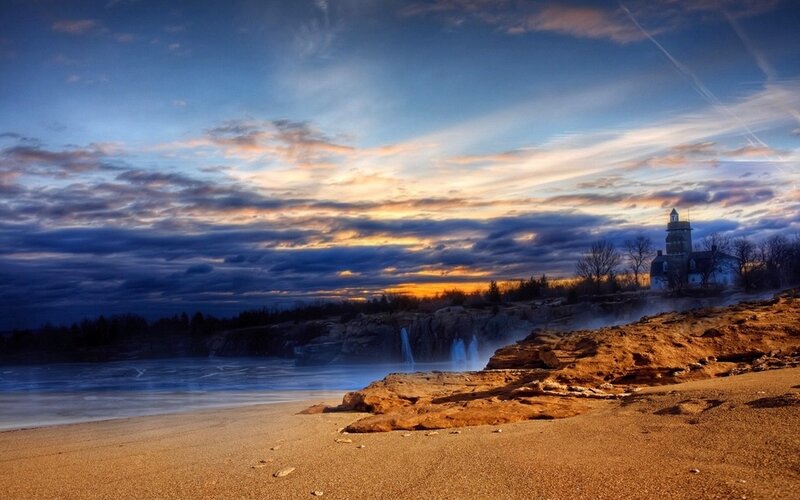 Lighthouse on Rocky Coast — Blue, Dramatic, Sunset, Photograph, Cliffs, Beach