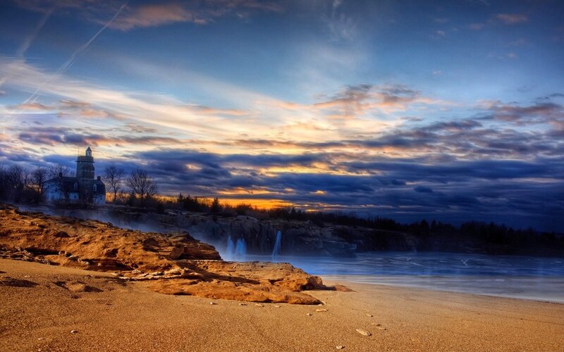 Lighthouse on Rocky Coast — Blue, Dramatic, Sunset, Photograph, Cliffs, Waterfall, Beach, Orange