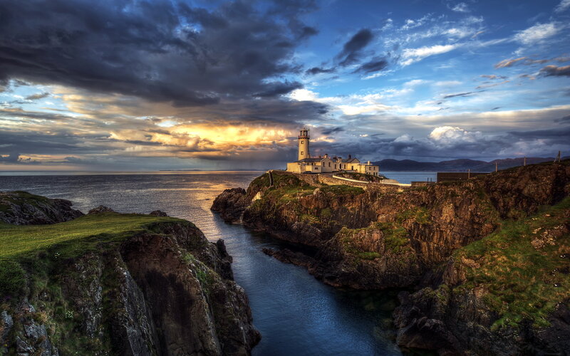 Lighthouse on Rocky Coast — Blue, Dramatic, Sunset, Photograph, Ocean, Cliffs, Clouds