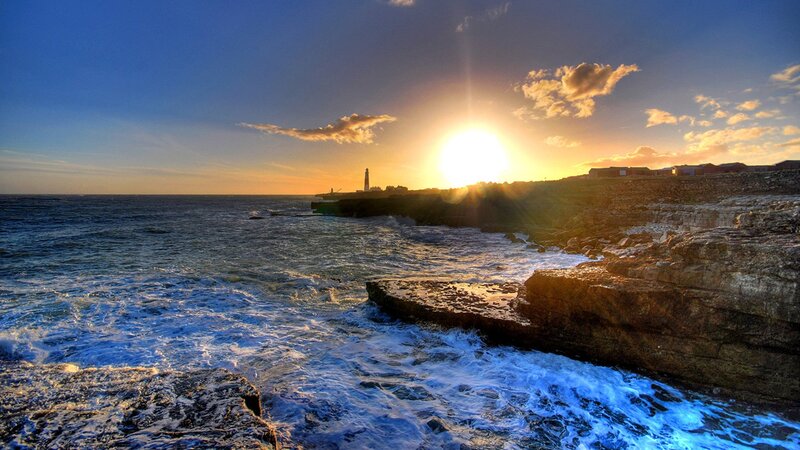 Lighthouse on Rocky Coast — Blue, Dramatic, Sunset, Photograph, Ocean, Cliffs, Sun
