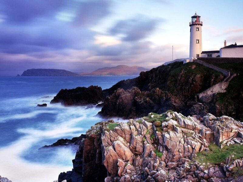 Lighthouse on Rocky Coast — Blue, Dramatic, Sunset, Photograph, Ocean, Mountains, Cliffs