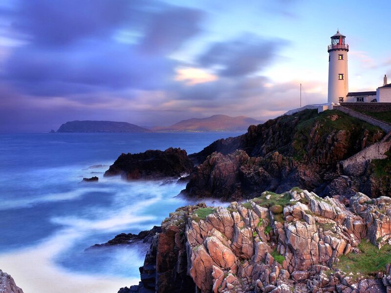 Lighthouse on Rocky Coast — Blue, Dramatic, Sunset, Photograph, Ocean, Mountains