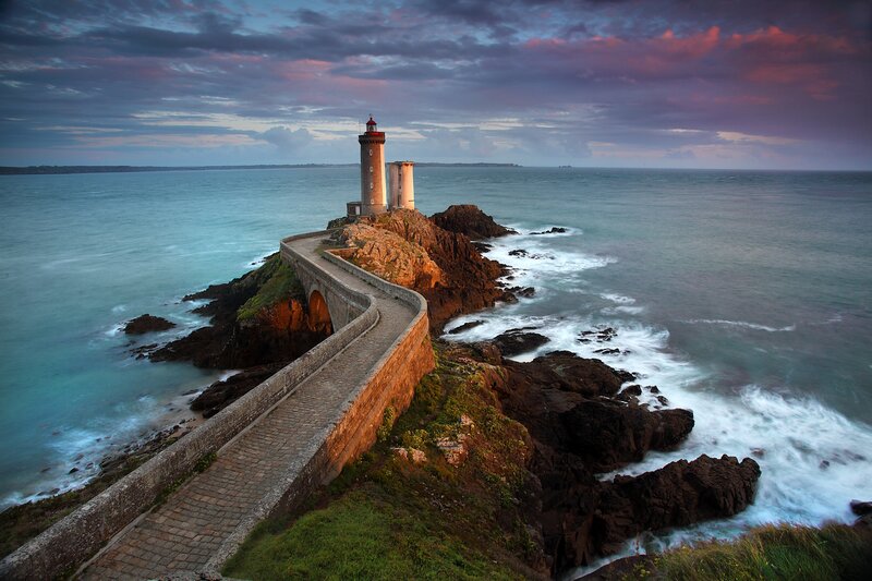 Lighthouse on Rocky Coast — Blue, Dramatic, Sunset, Photograph, Ocean, Sky