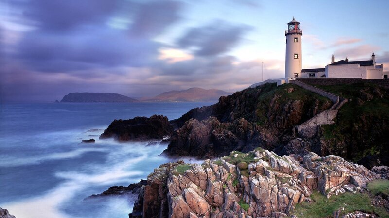 Lighthouse on Rocky Coast — Blue, Dramatic, Sunset, Photograph, Ocean