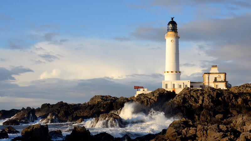 Lighthouse on Rocky Coast — Blue, Dramatic, Sunset, Photograph, Ocean Waves