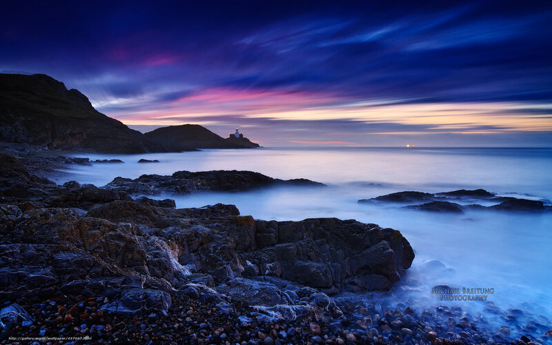 Lighthouse on Rocky Coast — Blue, Dramatic, Sunset, Photograph, Rocks, Ocean, Sky, Ship