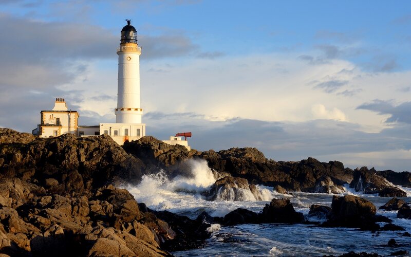 Lighthouse on Rocky Coast — Blue, Dramatic, Sunset, Photograph, Waves