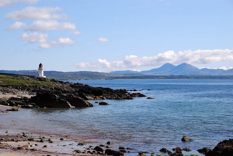 Lighthouse on Rocky Coast — Blue, Serene, Afternoon, Photograph, Mountains