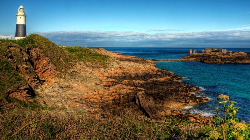 Lighthouse on Rocky Coast — Blue, Serene, Afternoon, Photograph, Ocean, Ruins