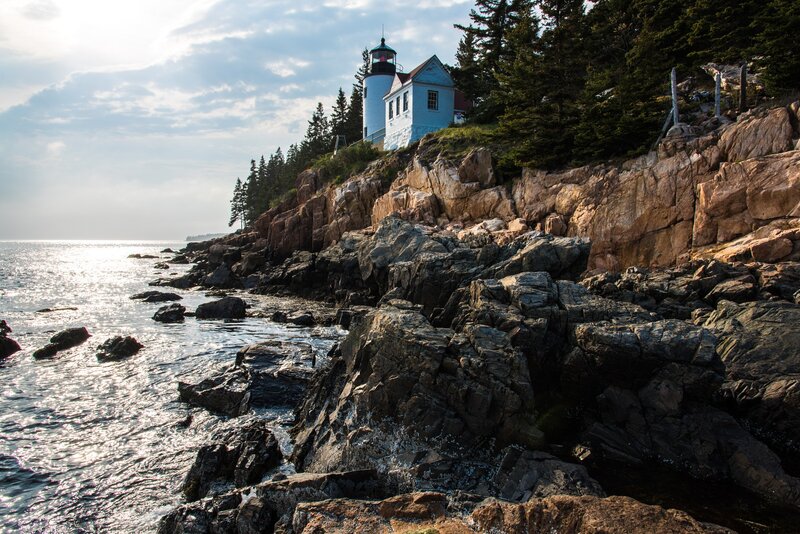 Lighthouse on Rocky Coast — Blue, Serene, Afternoon, Photograph, Ocean, Trees, Rocks