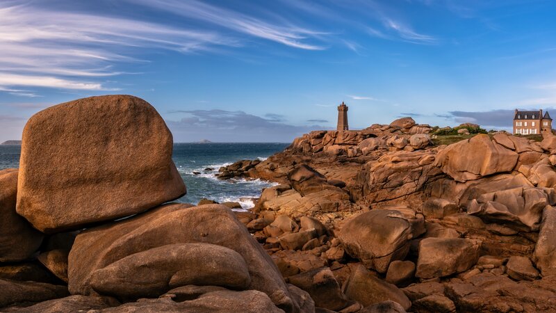 Lighthouse on Rocky Coast — Blue, Serene, Afternoon, Photograph, Rocks, Ocean