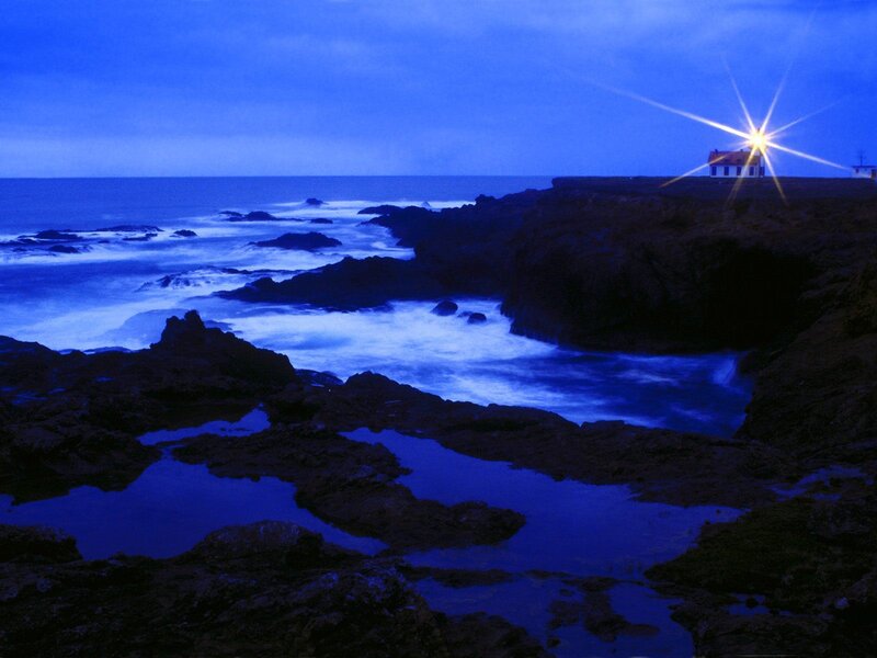 Lighthouse on Rocky Coast — Blue, Serene, Night, Photograph, Ocean, Rocks, Night Sky
