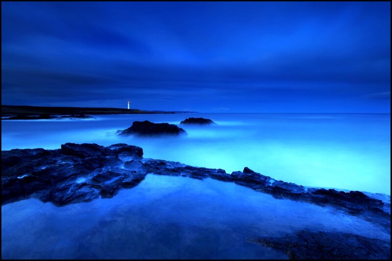 Lighthouse on Rocky Coast — Blue, Serene, Night, Photograph, Rocks, Ocean