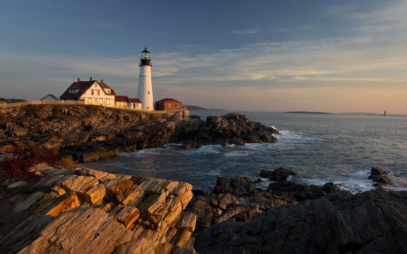 Lighthouse on Rocky Coast — Blue, Serene, Sunset, Photograph, Ocean, Rocks, Sky, Gray