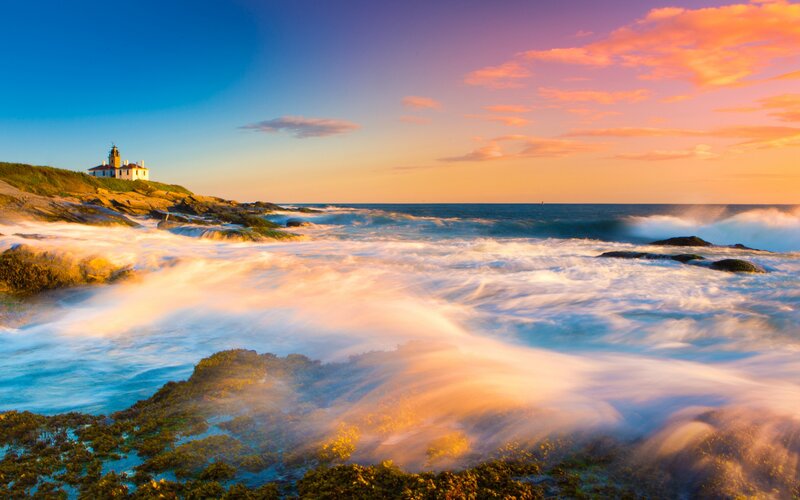 Lighthouse on Rocky Coast — Blue, Serene, Sunset, Photograph, Ocean Waves, Sky, Rocks