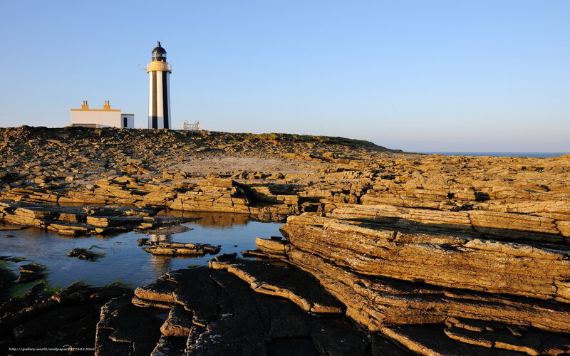 Lighthouse on Rocky Coast — Blue, Serene, Sunset, Photograph, Rocks, Ocean