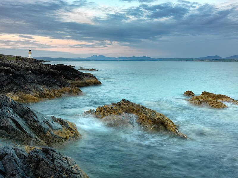 Lighthouse on Rocky Coast — Blue, Serene, Sunset, Photograph