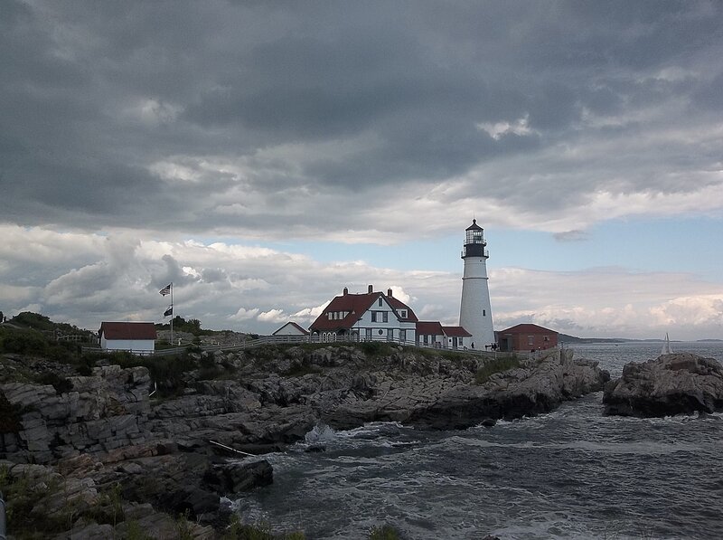 Lighthouse on Rocky Coast — Gray, Dramatic, Afternoon, Photograph, Rocks