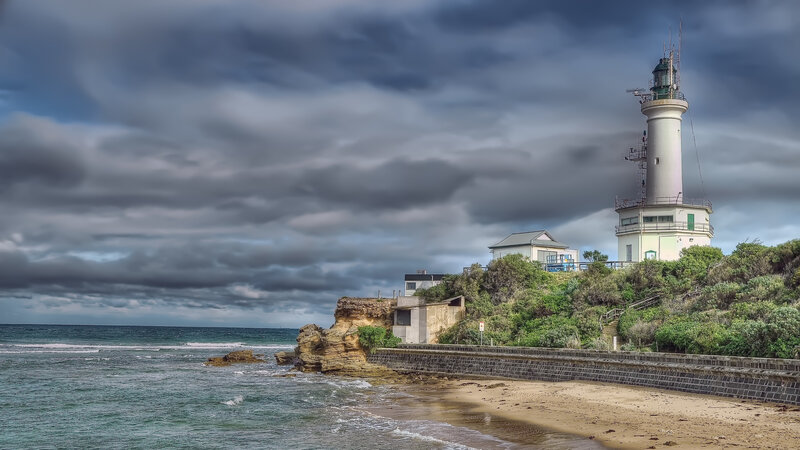 Lighthouse on Rocky Coast — Gray, Dramatic, Afternoon, Photograph