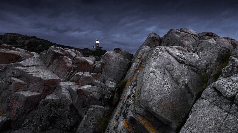 Lighthouse on Rocky Coast — Gray, Dramatic, Night, Photograph, Rocks