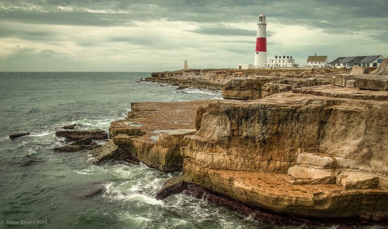 Lighthouse on Rocky Coast — Gray, Dramatic, Photograph, Ocean