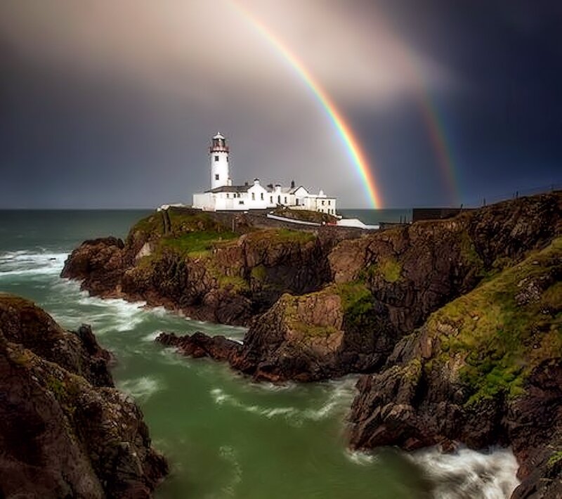 Lighthouse on Rocky Coast — Gray, Dramatic, Photograph, Rainbow