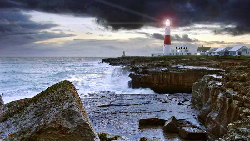 Lighthouse on Rocky Coast — Gray, Dramatic, Sunset, Photograph, Ocean, Cliffs
