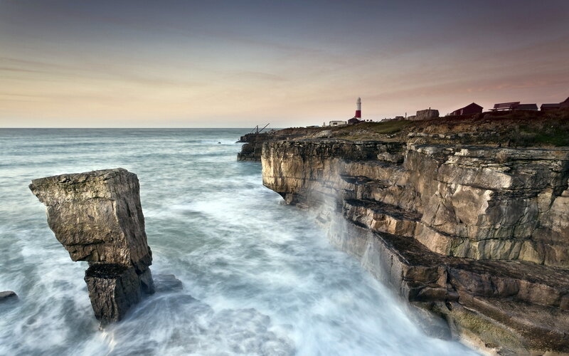 Lighthouse on Rocky Coast — Gray, Dramatic, Sunset, Photograph
