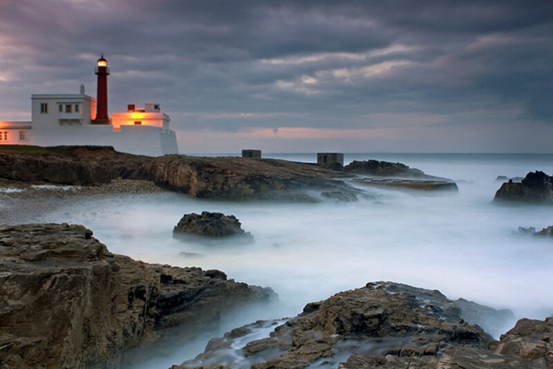 Lighthouse on Rocky Coast — Gray, Dramatic, Sunset