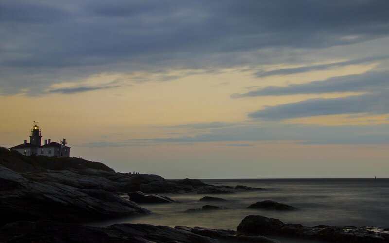 Lighthouse on Rocky Coast — Gray, Serene, Sunset, Photograph, Coastline