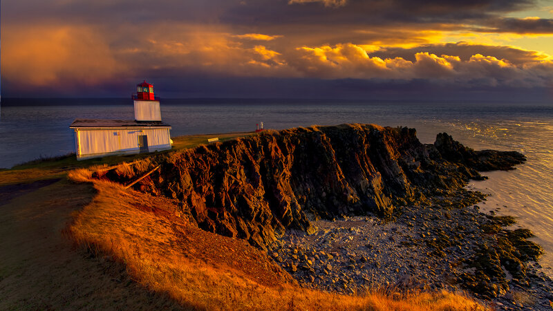 Lighthouse on Rocky Coast — Orange, Dramatic, Sunset, Photograph, Ocean, Cliffs, Sky