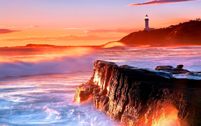 Lighthouse on Rocky Coast — Orange, Dramatic, Sunset, Photograph, Ocean, Rocks