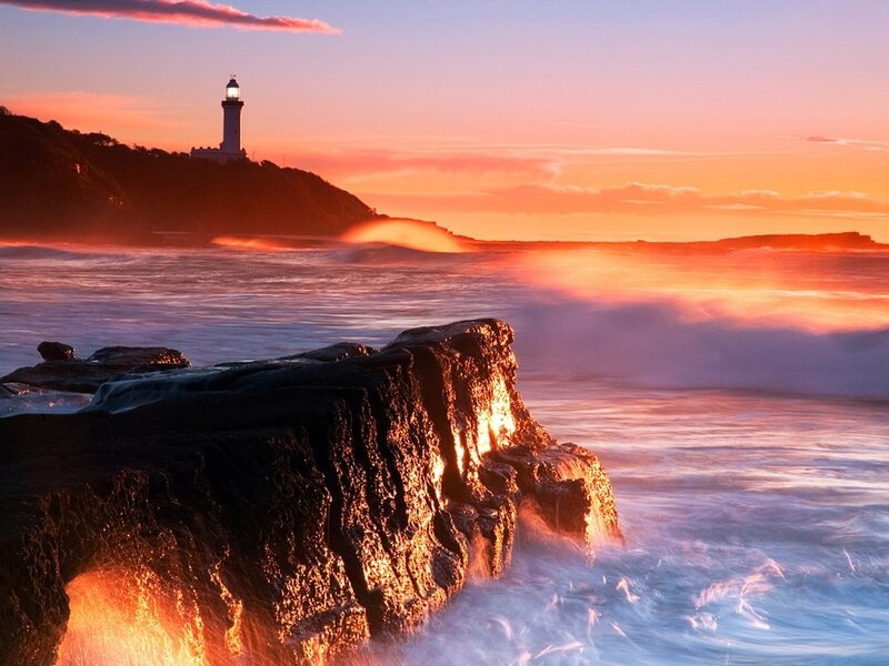 Lighthouse on Rocky Coast — Orange, Dramatic, Sunset, Photograph, Ocean, Waves, Cliff