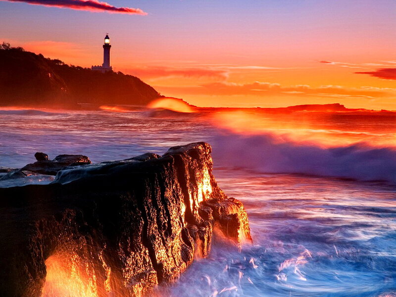 Lighthouse on Rocky Coast — Orange, Dramatic, Sunset, Photograph, Ocean, Waves