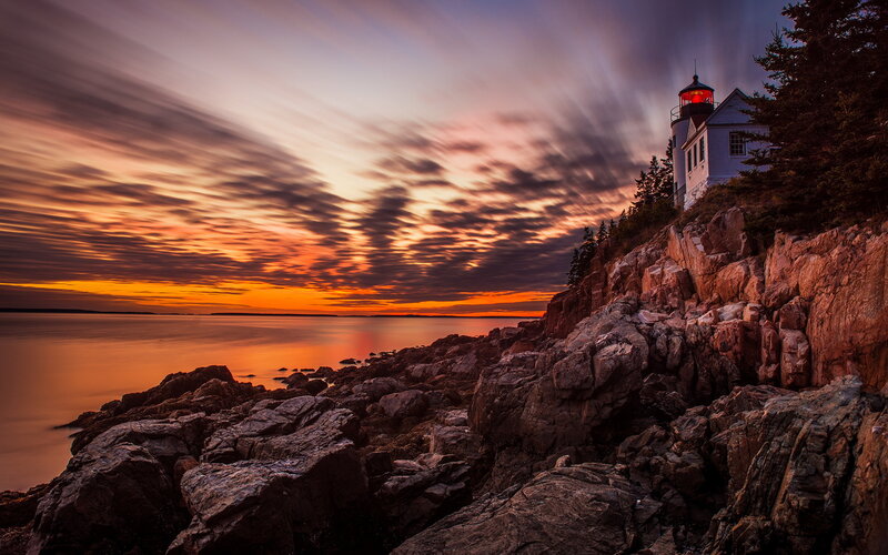 Lighthouse on Rocky Coast — Orange, Dramatic, Sunset, Photograph, Rocks, Sea, Trees