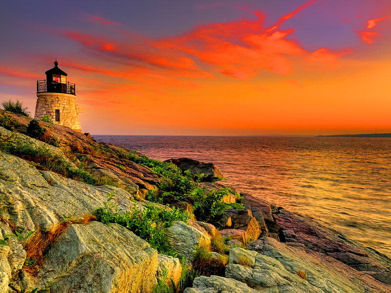 Lighthouse on Rocky Coast — Orange, Dramatic, Sunset, Photograph