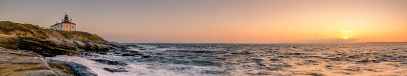Lighthouse on Rocky Coast — Orange, Serene, Sunset, Photograph, Ocean, Sky, Rocks