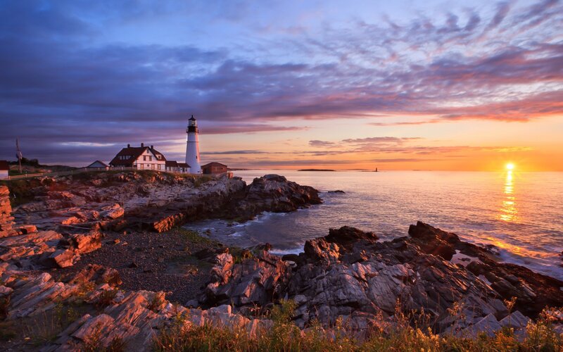 Lighthouse on Rocky Coast — Orange, Serene, Sunset, Photograph, Ocean, Sky
