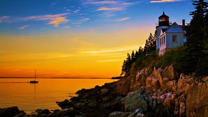 Lighthouse on Rocky Coast — Orange, Serene, Sunset, Photograph, Sailboat, Trees