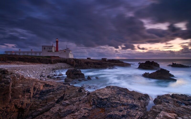 Lighthouse on Rocky Coast — Purple, Dramatic, Sunset, Photograph, Clouds
